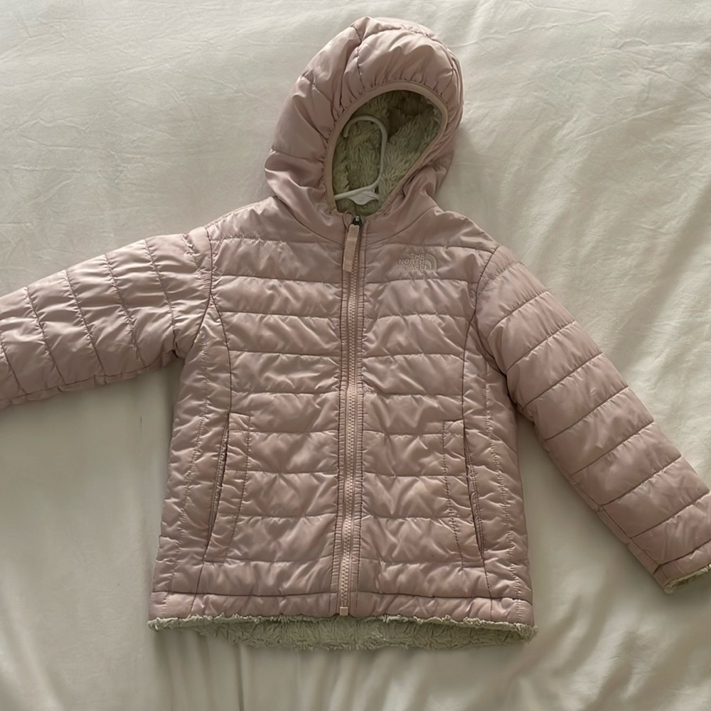 The North Face girls size 4T reversible jacket with a hood.